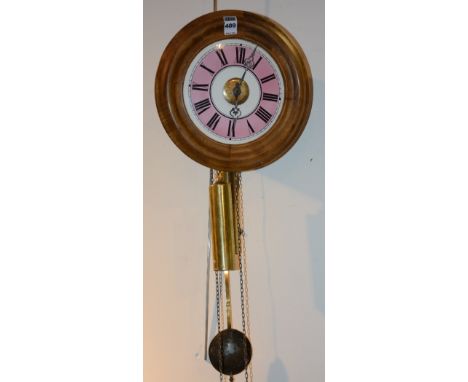 A circular wall clock circa early 20th century, the pink and white 7" enamel dial with Roman numerals, with brass pendulum an