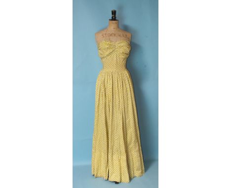 A vintage polka dot yellow and white cotton full-length strapless dress with ruched and boned bodice, size UK8 approximately,