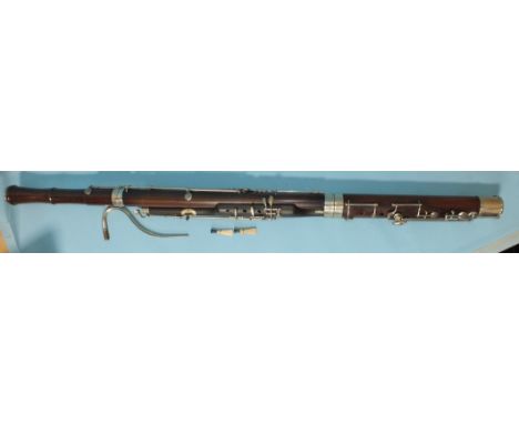 A Boosey &amp; Co. Ltd bassoon, numbered 28088, with crook and two reeds, in case, with further tubular case for carrying the