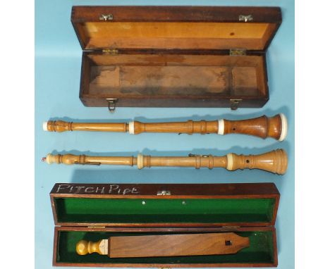 Two modern boxwood Baroque oboes, (one split), with brass keys, cased and a wooden pitch pipe with sliding stop, (no maker's 