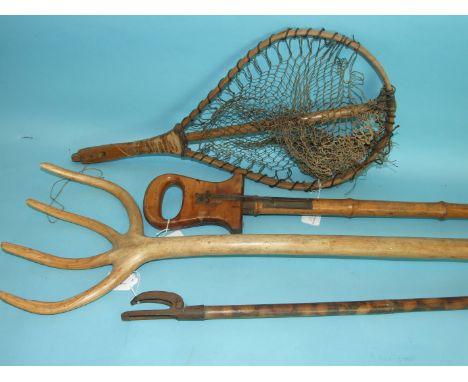 A bamboo shooting stick with wood seat, a rustic root-wood fork, a bamboo shafted fruit picker and other items. 