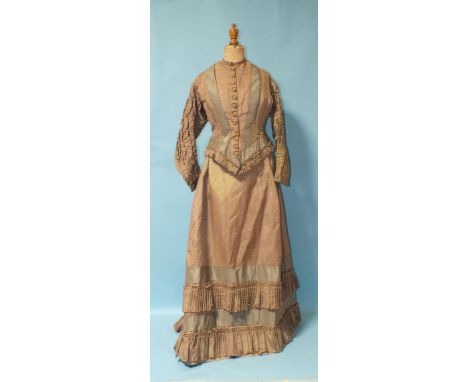A Victorian hand-stitched brown silk two-piece dress, decorated with two flounces and taupe silk panels, a heavily-embroidere
