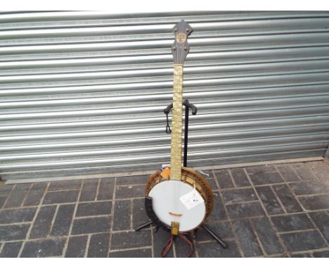 A Broadcaster five string banjo by J & A M London (the 5th peg removed to create four string instrument), the finger board, b