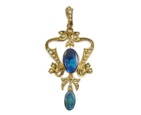 A late Victorian 15ct gold, two stone oval black opal and seed pearl cluster set drop pendant, 57mm, gross weight 5 grams.***