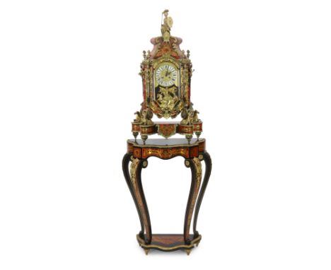 A Louis XV style brass mounted red boulle mantel clock on matching stand, with Britannia finial and hippocampi feet and ename