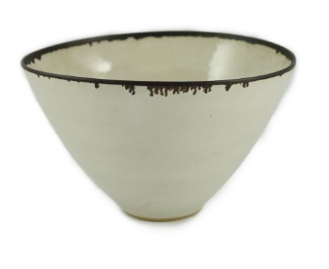 Dame Lucie Rie D.B.E. (1902-1995), a stoneware conical bowl, of slightly elliptical form, off white glazed with manganese rim