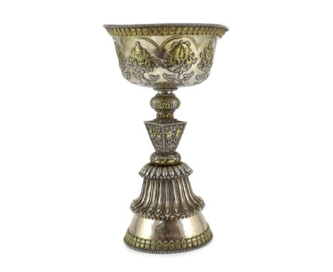 A large Tibetan silver and parcel gilt butter lamp, syou deng, 19th century repousse decorated with the eight Buddhist emblem