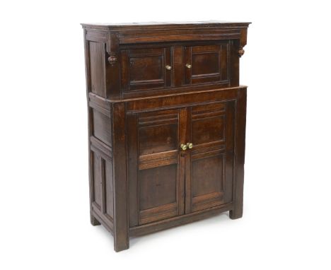 A 17th century oak court cupboard with moulded top and two panelled doors over two further panelled doors on stile feet, 113c