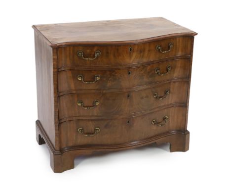 A George III mahogany serpentine dressing chest fitted four graduated long drawers, the top drawer with leather lined slide a