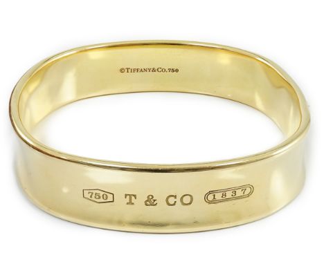 A modern heavy Tiffany &amp; Co 18ct gold shaped bangle, exterior diameter 65mm, 82.2 grams, no box.***CONDITION REPORT***A f