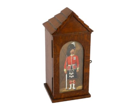 A late Victorian oak smoker’s cabinet modelled as a sentry box with a watercolour panel by Richard Simkin (1840-1926), with s