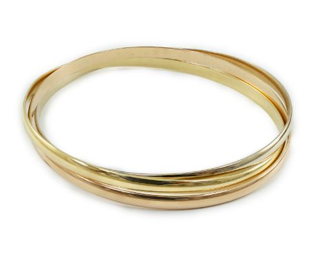 A modern three colour 18ct gold Cartier Russian triple bangle, signed and numbered B46436, 30.6 grams, with Cartier box.***CO