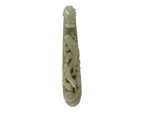 A large Chinese pale celadon jade ‘dragon’ belt hook, 18th/19th century, typically carved and pierced with a chilong, dragon’