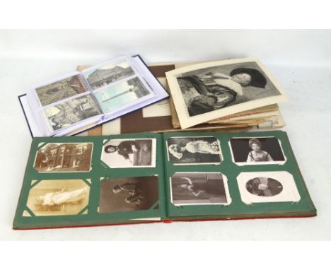 A quantity of postcards including an album of topographical humorous and trench cards, a further album with portrait cards wi