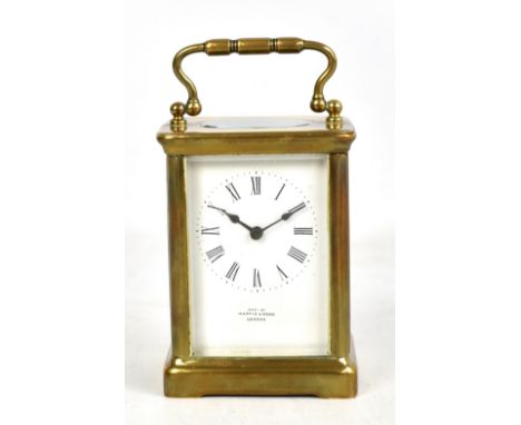 A circa 1900 French brass carriage clock retailed by Mappin &amp; Webb of London with white enamel dial set with Roman numera