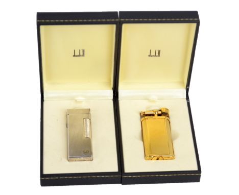 DUNHILL; two cased gold and silver plated cigarette lighters with engine turned finish, also a group of empty pouches and box