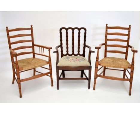 A pair of string seated ladder back elbow chairs raised on turned front legs and a further mahogany elbow char (3).