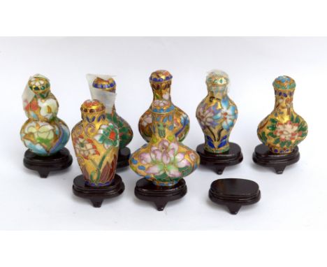 Seven modern Chinese enamel decorated snuff bottles and stands.&nbsp;