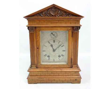 A late 19th century satin walnut mantel clock with architectural stepped case, rectangular silvered dial inscribed 'Examined 