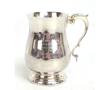 An Elizabeth II hallmarked silver baluster mug with scrolling loop handle and presentation inscription from Singleton Birch L