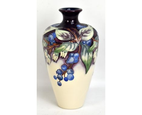 MOORCROFT; a tubeline decorated 'Blueberries' pattern baluster vase on purple and white ground, impressed marks, printed star