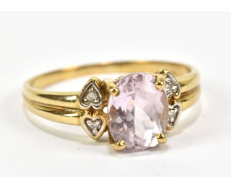 A 9ct yellow gold dress ring set with light purple coloured oval cut stone and white stone chips in heart settings, approx 2.