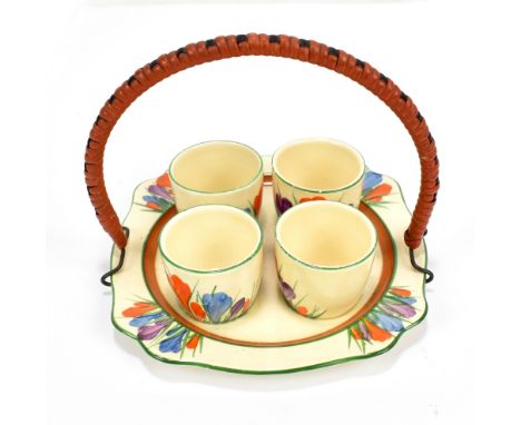 CLARICE CLIFF; a Newport Pottery Bizarre 'Crocus' pattern egg cruet-stand and cups with basket weave handle, printed marks to