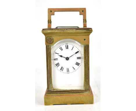 A circa 1900 French brass carriage clock with white enamel dial set with Roman numerals and numbered 22 to the door, sold wit