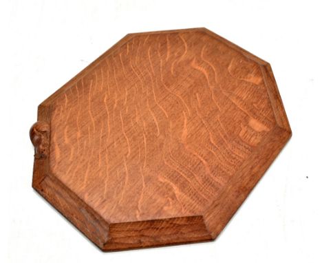 ROBERT THOMPSON OF KILBURN; a Mouseman oak bread or cheeseboard of octagonal form bearing signature mouse, 30.5 x 25cm.