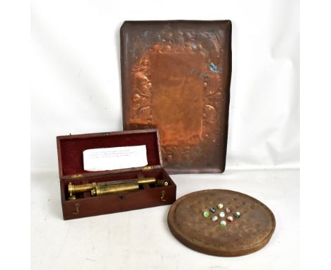 A cased brass steam engine efficiency recorder, a fish motif copper tray, a small group of marbles and a marble board.
