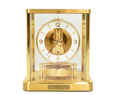 JAEGER-LECOULTRE; a gilt brass 'Atmos' mantel clock, the chapter ring set with Arabic and baton numerals, the exposed 14 jewe