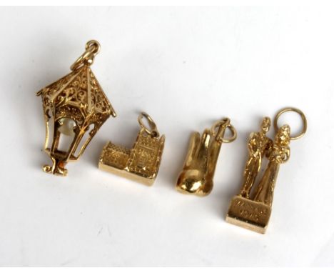 Two 9ct yellow gold charms depicting a married couple and a church, also a yellow metal lantern charm set with cultured pearl