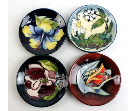 MOORCROFT; four floral tubeline decorated pin dishes including a 'Hibiscus' example, diameter each 11.5cm (one second quality