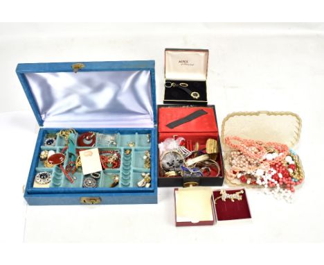 A collection of costume jewellery including carnelian-type pendants and beads, clip earrings, enamelled bangle, Cupid and Psy