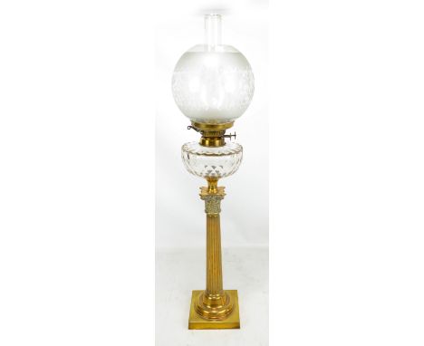 An early 20th century brass oil lamp with etched globular shade, clear cut glass reservoir with Hinks Patent and Corinthian c