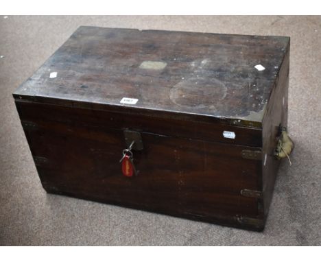 A mid-19th century Indian teak and brass mounted rectangular trunk with hinged lid bearing plaque inscribed 'J.E. Geary', wid