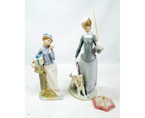 LLADRÓ; a figure of a woman with umbrella holding a dog (umbrella af), height 38.5cm, and a Nadal figure of a lady with prese