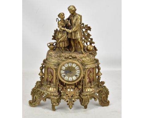 FRANZ HERMLE &amp; SON; a 20th century German brass figural mantel clock surmounted with courting couple, the enamelled chapt
