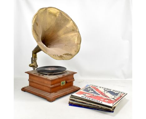 A vintage HMV record player with horn and a group of vinyls including the Stone Roses, Queen, Supertramp, Sugar Hill, Dire St