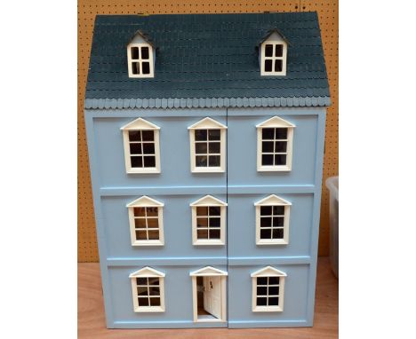 A contemporary doll's house sold with a large quantity of furniture, prints hanging on the wall, lighting, etc.