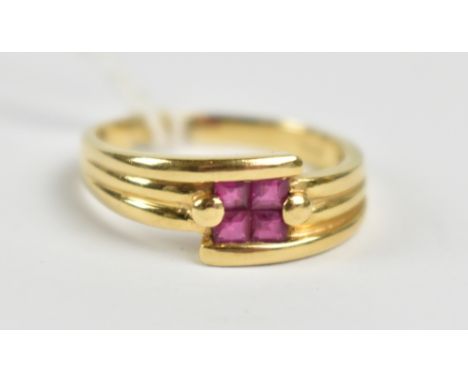 An 18ct yellow gold and ruby four stone ring, size P, approx 4.4g, sold with receipt from The Royal Shop Barbados.Additional 