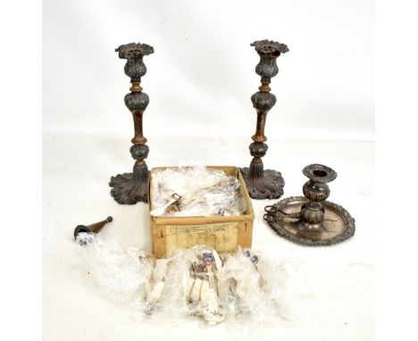 A pair of silver plated candlesticks, a plated chamberstick and a quantity of plated butter knives with enamel town crests.