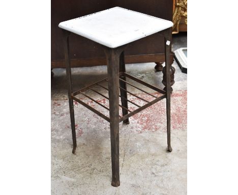 An early 20th century wrought iron and enamel topped two tiered table, the underside of the white enamel top stamped 'Richmon