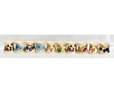 MOORCROFT; ten floral tubeline decorated mugs on cream grounds, all with impressed marks and various year ciphers to bases (1