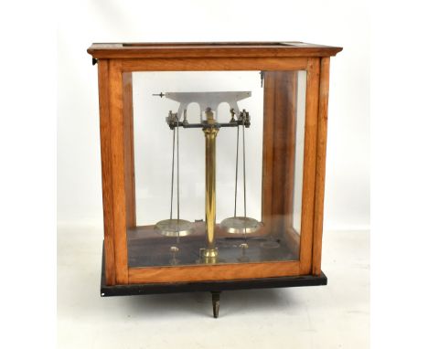 A cased set of scientific scales and a boxed set of weights.&nbsp;
