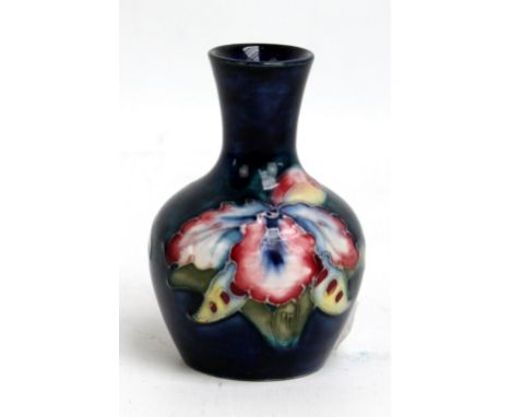 MOORCROFT; a floral tube line decorated 'Orchid' pattern miniature baluster vase with flared rim, impressed marks to base, he
