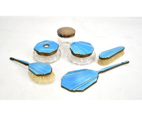 An Art Deco five piece dressing table set with blue guilloche enamel decoration, also a silver topped glass jar (6).Additiona