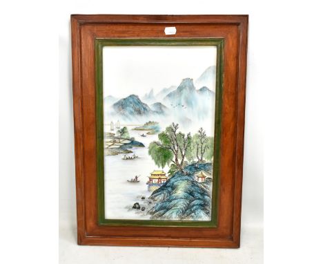 A Chinese hand painted rectangular porcelain plaque depicting a mountainous landscape with figures in boats in foreground, 42