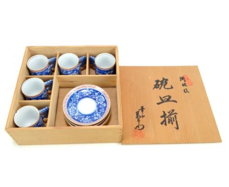 A boxed Japanese floral decorated tea set with moulded handles comprising five cups (one af) and five saucers.Additional Info