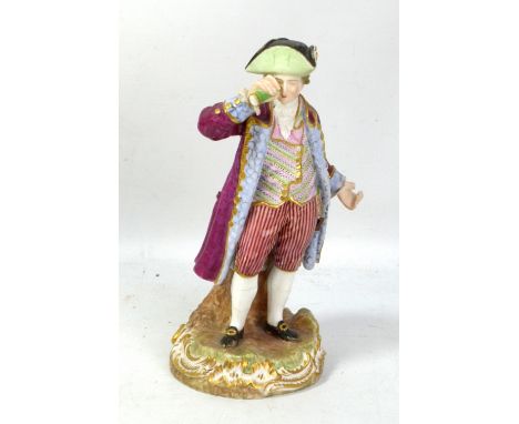MEISSEN; a 19th century figure of a gentleman holding a telescope to his right eye, painted marks to base, height 19cm (af).A